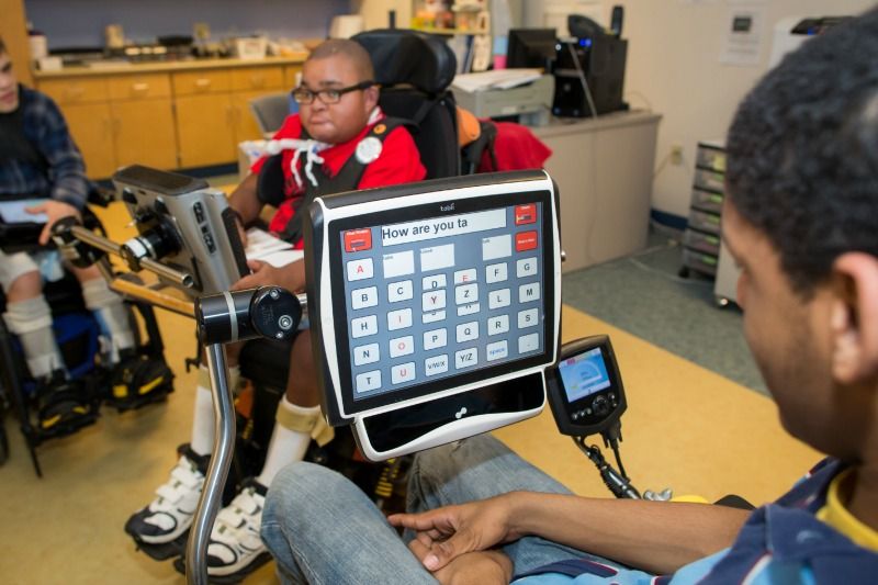 A person with disability using assistive technology